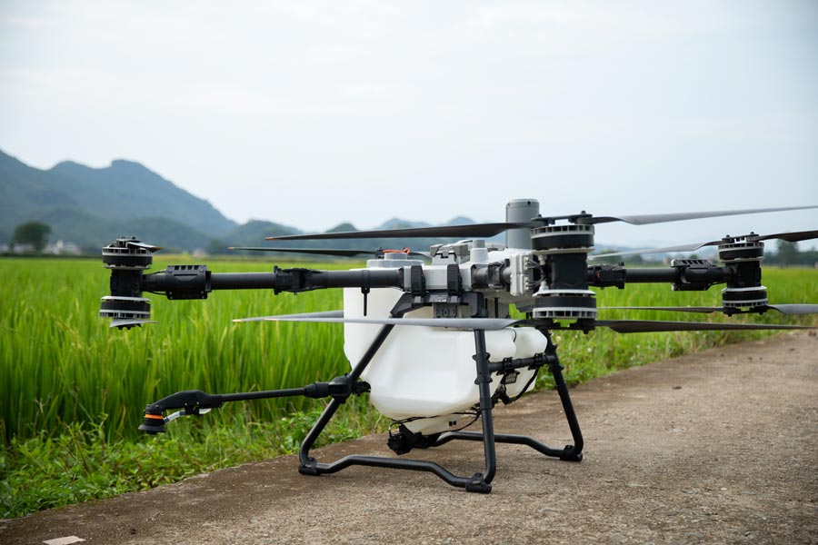 DJI Agras T100 150L Spreading System – side view in field