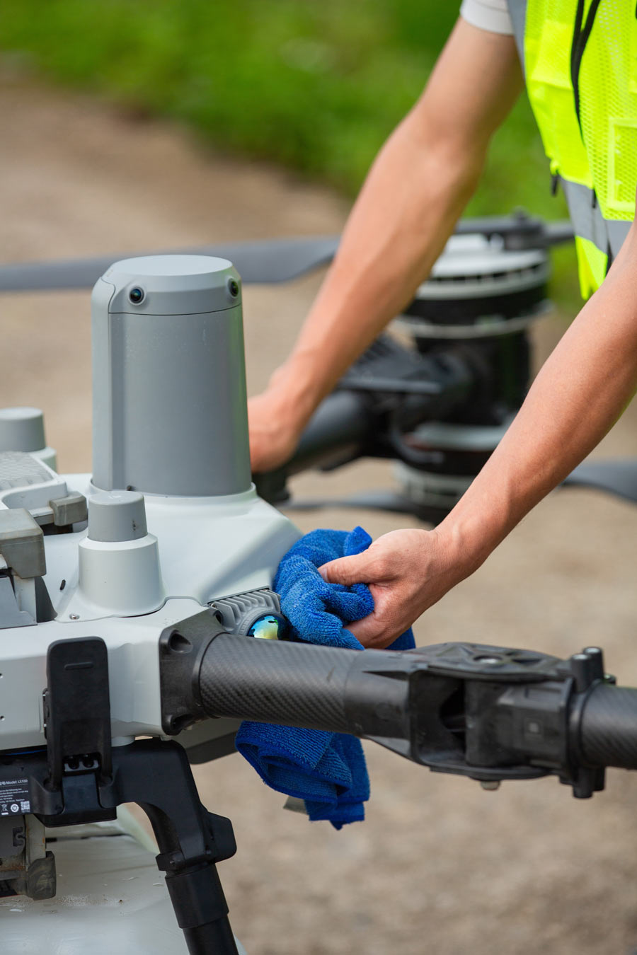 DJI Agras T100 lifting supplies across farmland